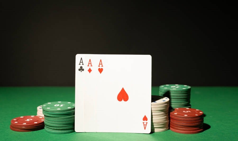 3 poker cards on a Casino Table standing up