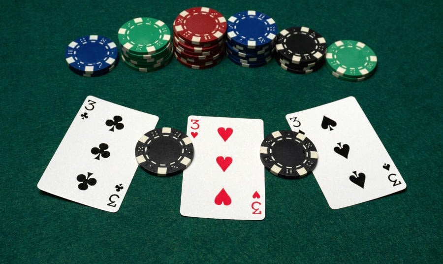 3 poker cards on a Casino Table