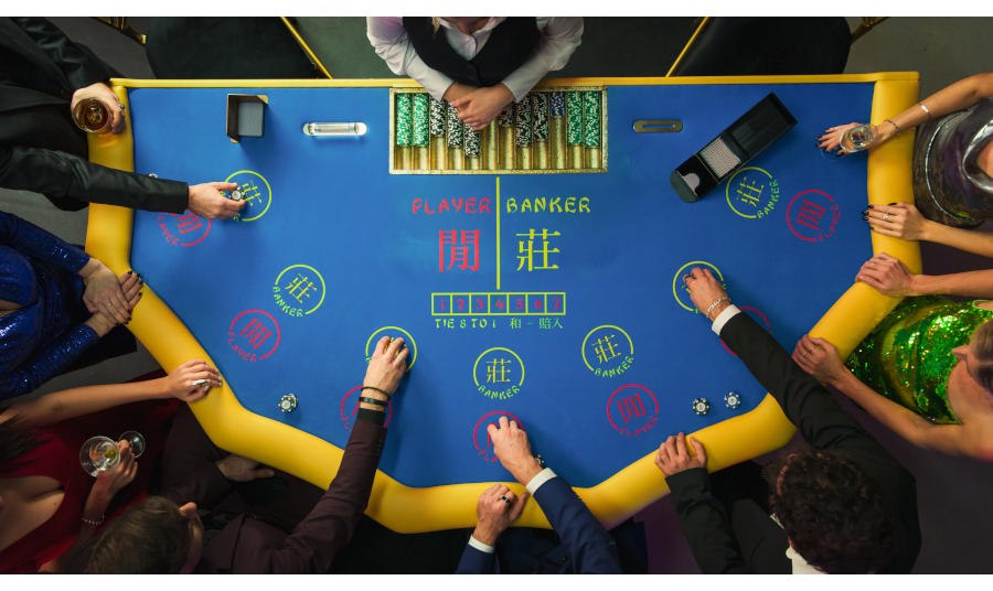 Top Down View Of Glamorous Casino Gamblers Placing Bets at Baccarat Table.