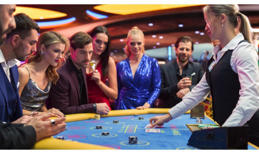 Baccarat table with people standing around it