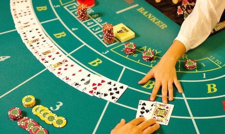 Playing cards and casino chips arranged on a baccarat table