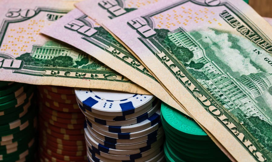 Poker casino chips and money close up.