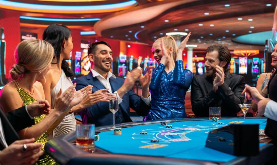 People gathered around a blackjack table at a casino