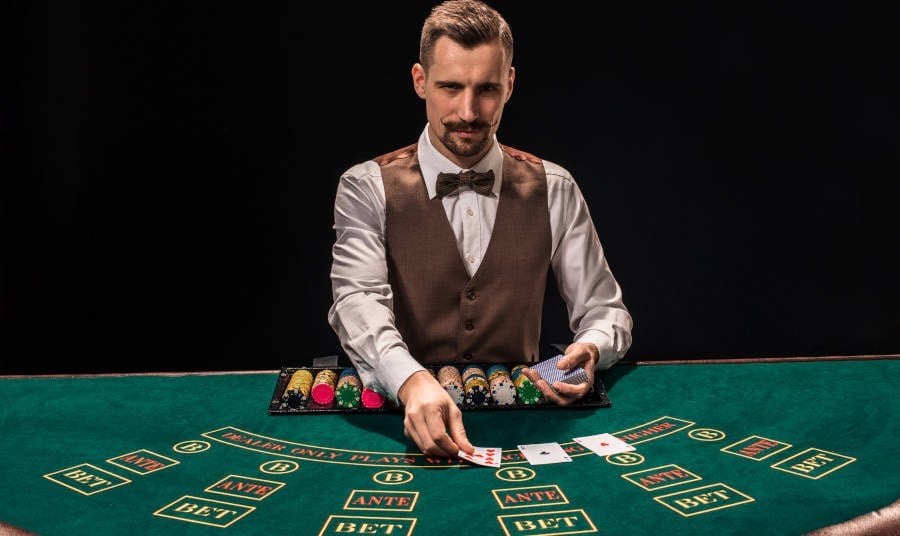 Closeup of a dealer dealing playing cards on at a Casino table