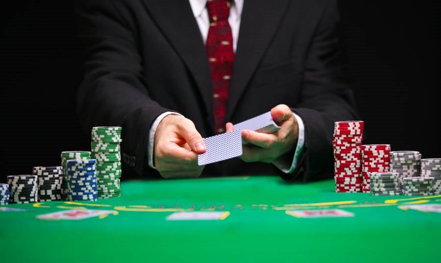 Closeup of a dealer dealing playing cards on a Casino table