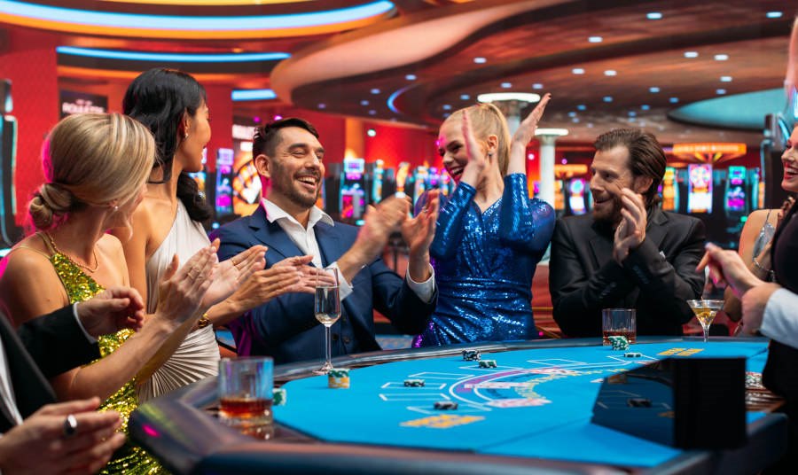 Men and women having fun at a blackjack table in a casino