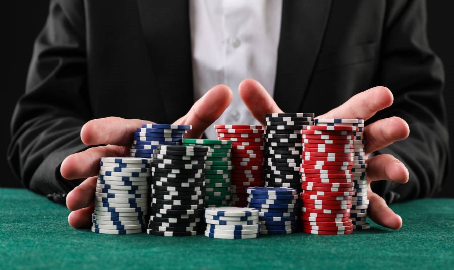 Close up of Man with casino chips playing poker at gambling table