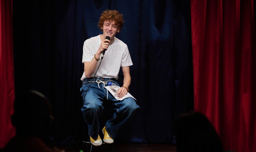 Young man performing at a comedy show