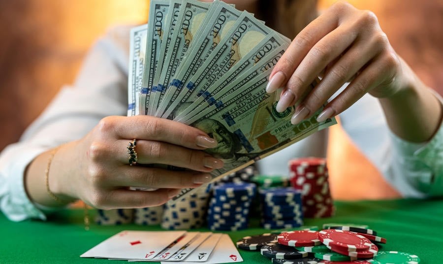 player counts chips for money and raises while playing casino poker.