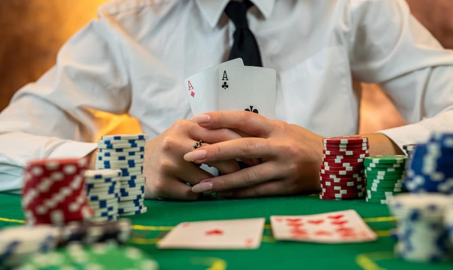 Woman's hands hold poker cards