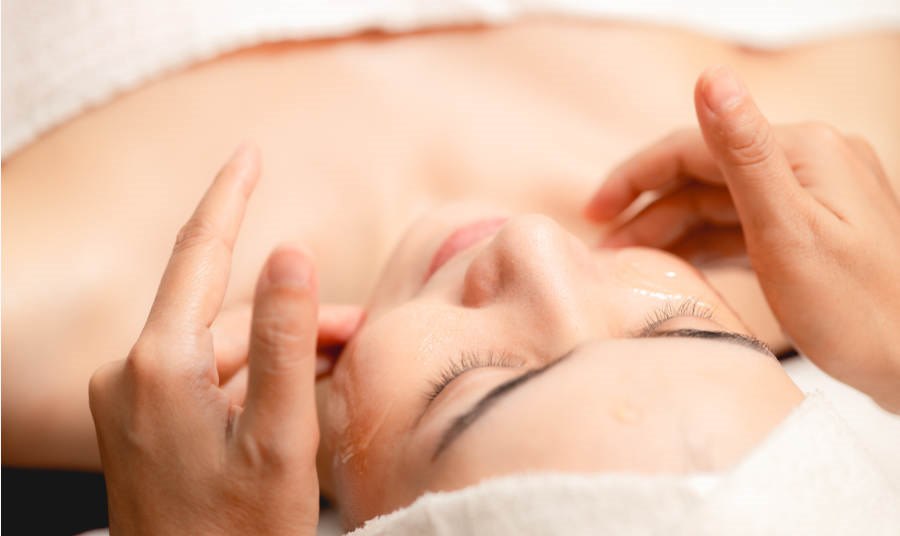 Women getting Facial Massage at a spa closeup