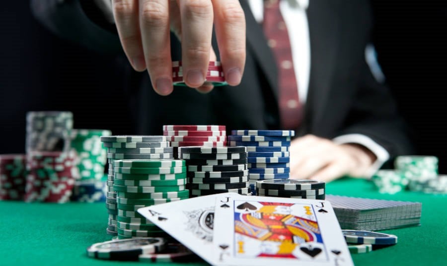 Man placing chips on a gaming table