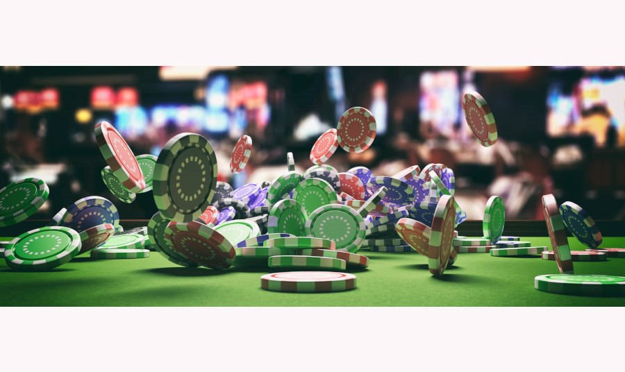 Poker chips falling on green felt poker table