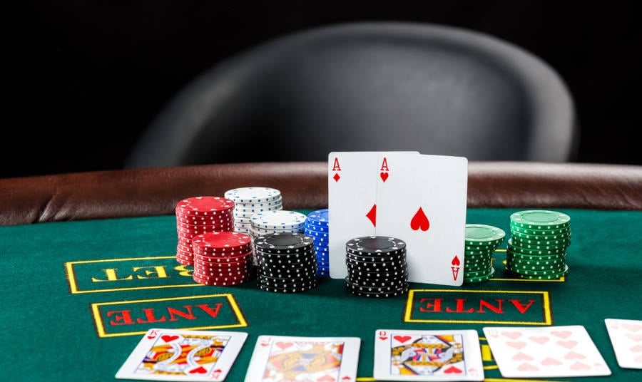 Poker play chips and cards on the green table