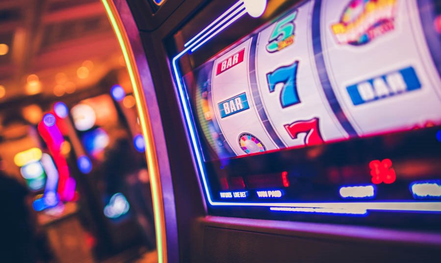 Close up of a slot machine against a casino wall
