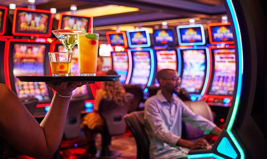man sitting at a slot machine at Cache Creek Casino