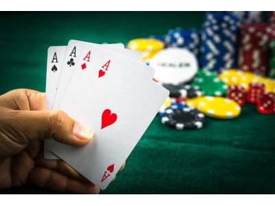 close up of cards in a hand with chips