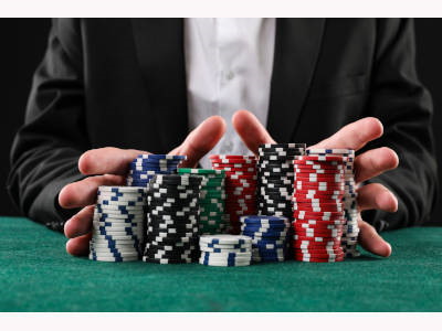Man pushing chips forward on a poker table